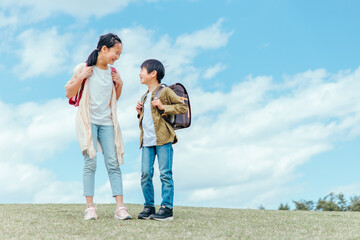 空と小学生の男女
