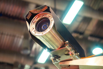 Vandal-proof camera. CCTV under roof of building. Security camera with metal case. Metal security...