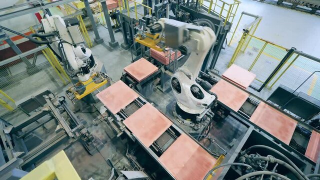 Cybernetic machines are transporting copper plates