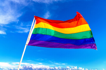 Rainbow LGBT gay flag against sky