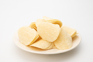 Potato chips in white bowl on white background, Close up....