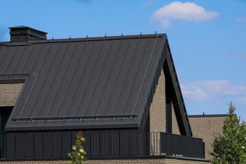 A modern family home with a trendy design. Gray roof, sand walls.