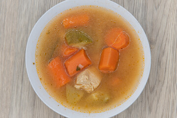 Hearty bowl of chicken soup with large chunks of carrots and meat for a complete meal