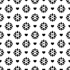 Seamless pattern on black and white flowers and hearts background.