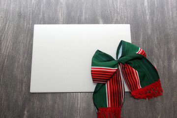 Tricolor party bow: green, white and red. The flag colors of Mexico and Italy for the holidays along with a chopping board as a banner for copy
