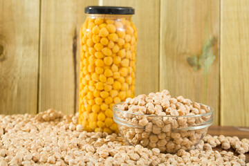 Glass bowl of raw chickpeas on wooden surface. Healthy and nutritious food