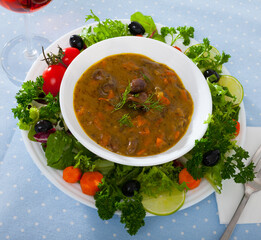 Chicken heart goulash served in ceramic bowl with vegetables