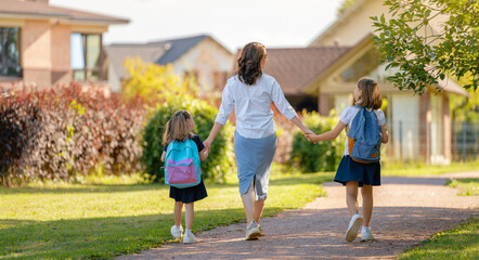 Parent and pupils going to school