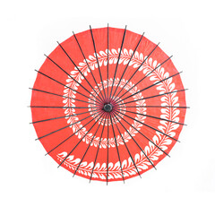 Red japanese umbrella with pattern isolated on white background. Symbol of protection. Traditional and culture design. © tampatra