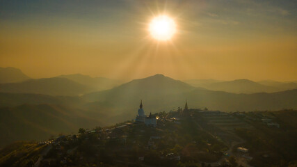Naklejka premium Top view Landscape view of public big white Buddha statue at Wat Phra That Pha Son Kaew Temple with mountain view background at Khao Kho, Phetchabun ,Thailand.