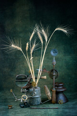 Abstract still life with seams of wheat, soldering lamp, drill and magnifying glass