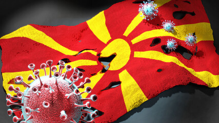 Covid in Republic of North Macedonia - coronavirus attacking a national flag of Republic of North Macedonia as a symbol of a fight and struggle with the virus pandemic in this country, 3d illustration