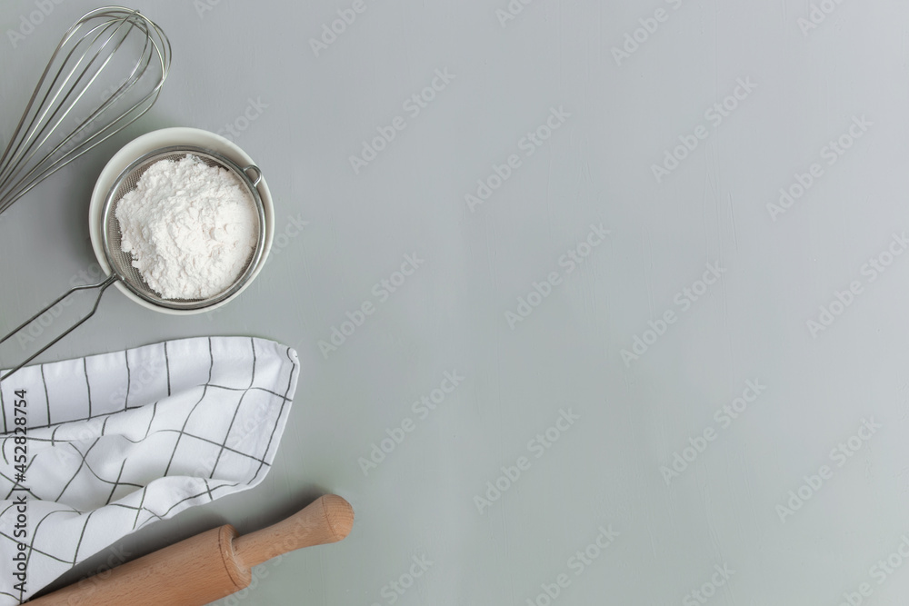 Wall mural Baking concept flat lay. Ingredients, kitchen utensils, grey concrete background