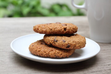 Pile of three delicious cookies on white plate