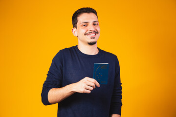Portrait of a boy holding a Brazilian passport in his hands. Travel and migration concept