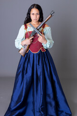 A pirate woman wearing a brocade corset and silk skirt and holding guns