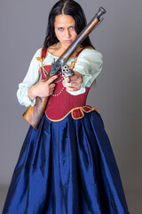 A pirate woman wearing a brocade corset and silk skirt and holding guns