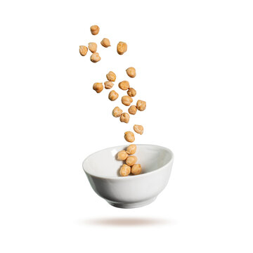 Chickpeas is flying in the air. Chickpeas and white plate isolated on white background. Creative concept cooking food.