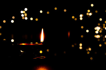 Close view of lit diya lamp. Lamp made out of silver metal lit during festival.