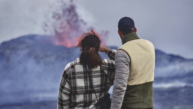 Erupting Volcano as Courageous Adventurers Observe Closely Close Together