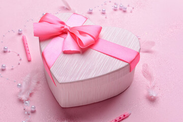Composition with gift box and candles on color background, closeup