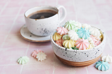 Cup with coffee and small meringues