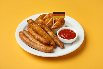 Plate with tasty sausages, sauce and flag of Germany on color background