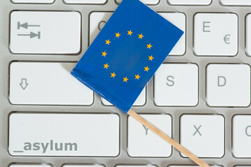 Computer, Flagge der EU und Taste für Asyl