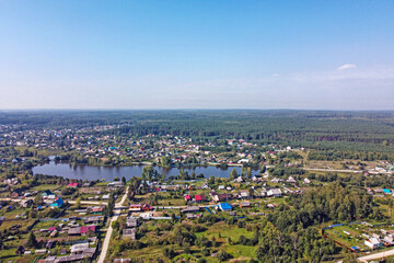 Top view of a small village in the forest on a summer day
