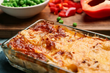 Baking dish with tasty vegetable lasagna on table, closeup