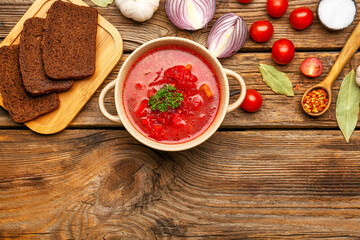 Composition with tasty borscht on wooden background