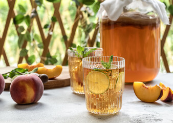 Homemade fermentation. Kombucha tea slightly alcoholic, lightly effervescent drink with peach and lime.