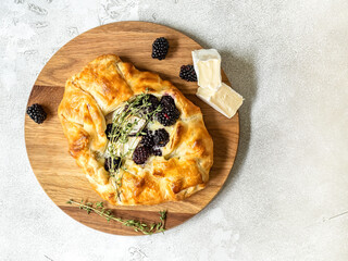Baked brie cheese and blackberry open pie galette with thyme