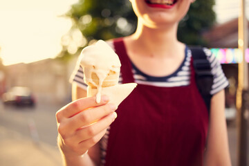 short haired woman eating ice cream outdoors in summer