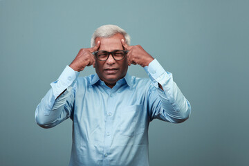 Elderly man of Indian origin feeling head ache