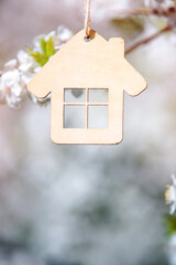 Symbol of the house on the branches of a flowering cherry
