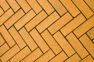 Yellow block pavior driveway. Seamless texture of street tiles. Pattern of yellow sidewalk tiles. Paved path pattern, brick path road. Cobblestone textured detailed ground concrete pavement