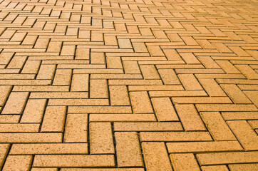 Yellow block pavior driveway. Seamless texture of street tiles. Pattern of yellow sidewalk tiles. Paved path pattern, brick path road. Cobblestone textured detailed ground concrete pavement