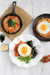 Homemade Kimchi Fried Rice Topped with Fried Egg on Skillet, Overhead View