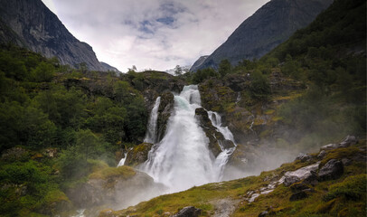 Fototapeta na wymiar Panoramic view to kleivafossen waterfall at briksdalselva river, Briksdalsbreen glacier, Norway