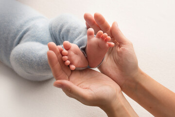 photo with children's legs that are held in the palms of mom and dad. family album. newborn feet.
