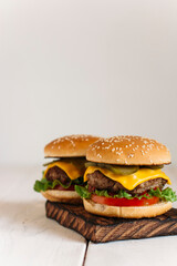  juicy burgers on a chopping board