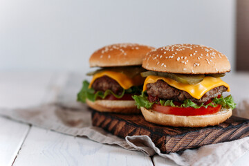  juicy burgers on a chopping board