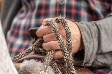 Close-up of a person´s hand holding reins - obrazy, fototapety, plakaty