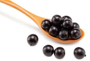 black currant in wooden spoon isolated on white background. macro. clipping path