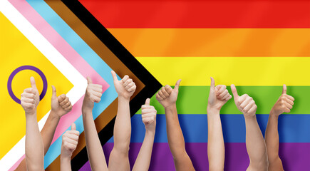 lgbtq, trans and intersex rights concept - multiracial human hands showing thumbs up over rainbow...