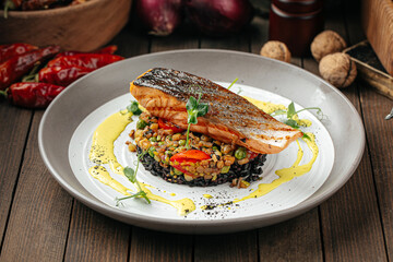 Gourmet salmon fillet with creamy basil sauce and black rice