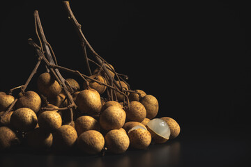 Close-up longan (Dimocarpus longan) isolated on black backdrop used for fruit background.