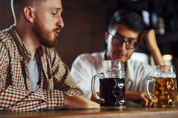 People in casual clothes sitting in the pub and having conversation