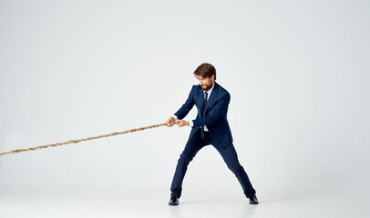 business man in a suit pulls the rope emotions studio